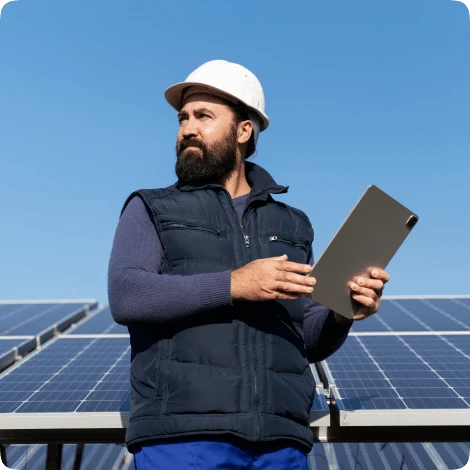 Nuon Energy technician with a tablet standing in front of a solar array
